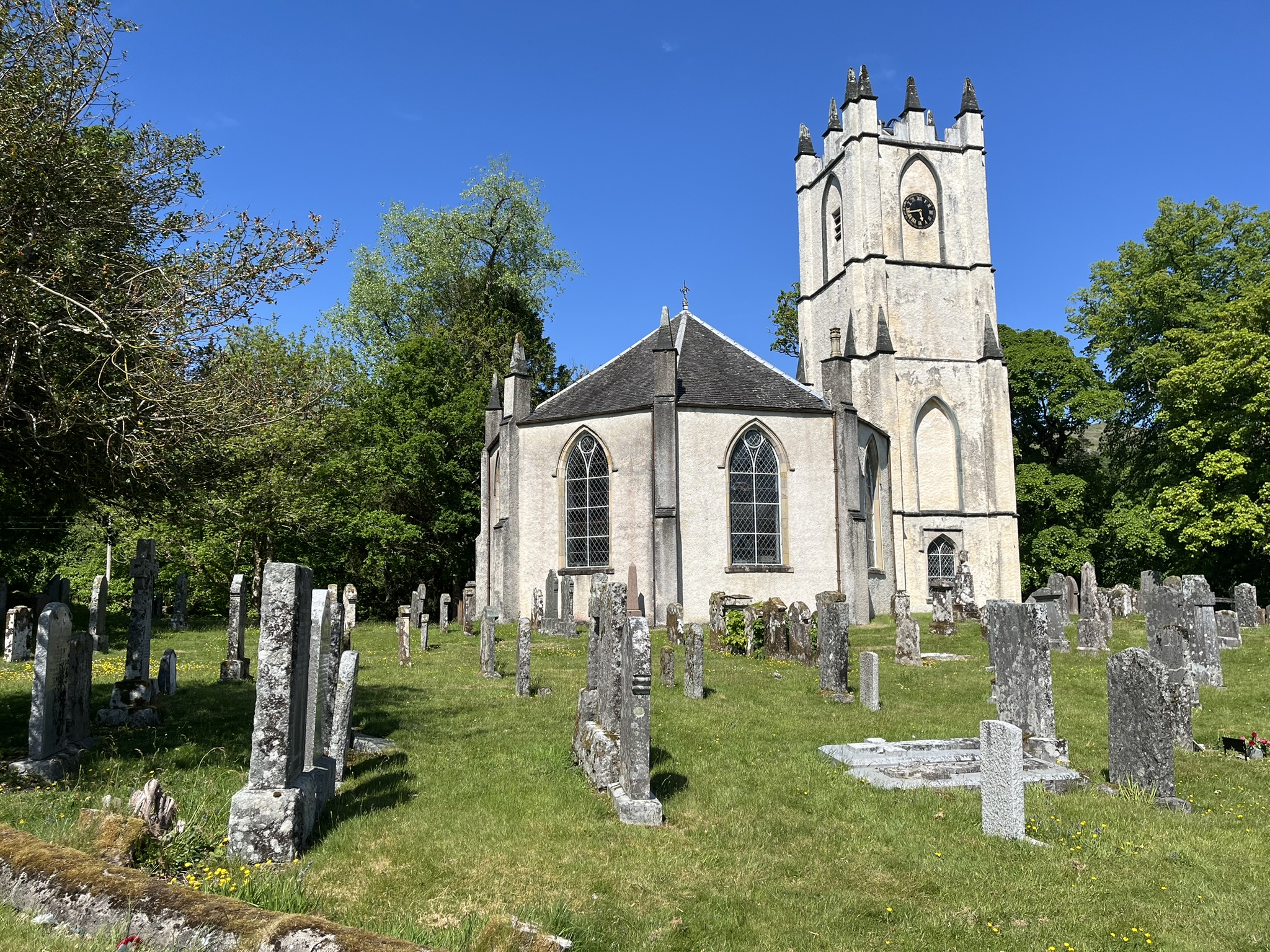 The exterior of Glenorchy Parish Church at Dalmally, an octagonal stone church with a square tower, seen across the churchyard.
